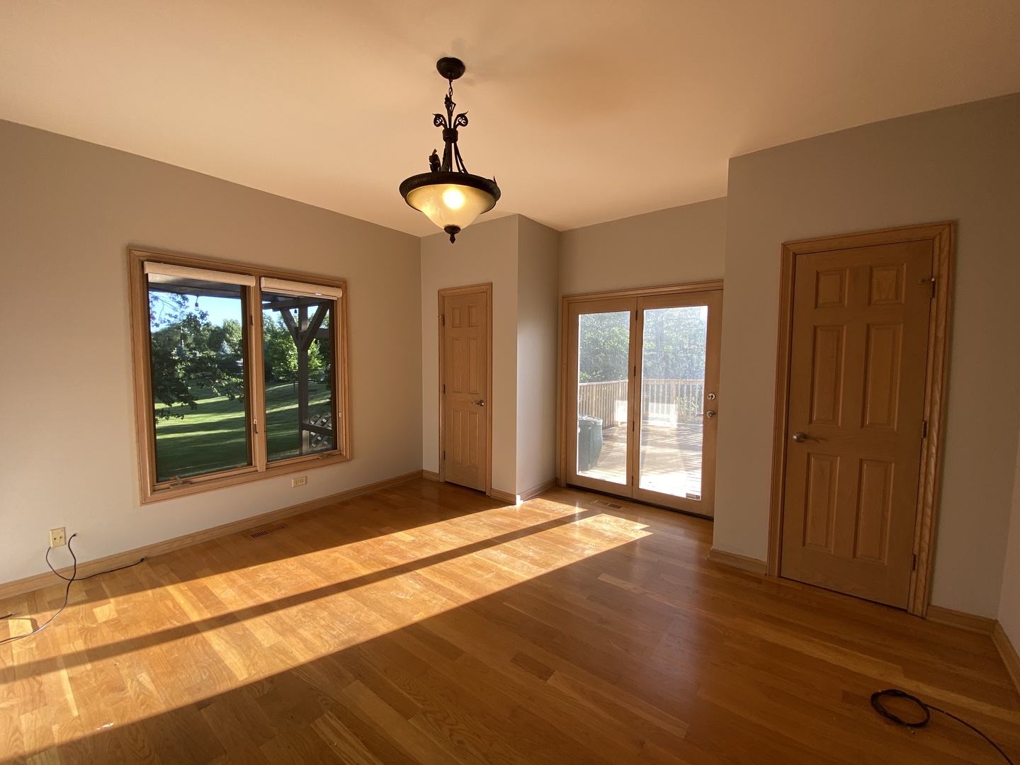817 Turnbridge Circle Naperville, IL 60540 - Photo 12 of 42 a view of an empty room with a window and wooden floor
