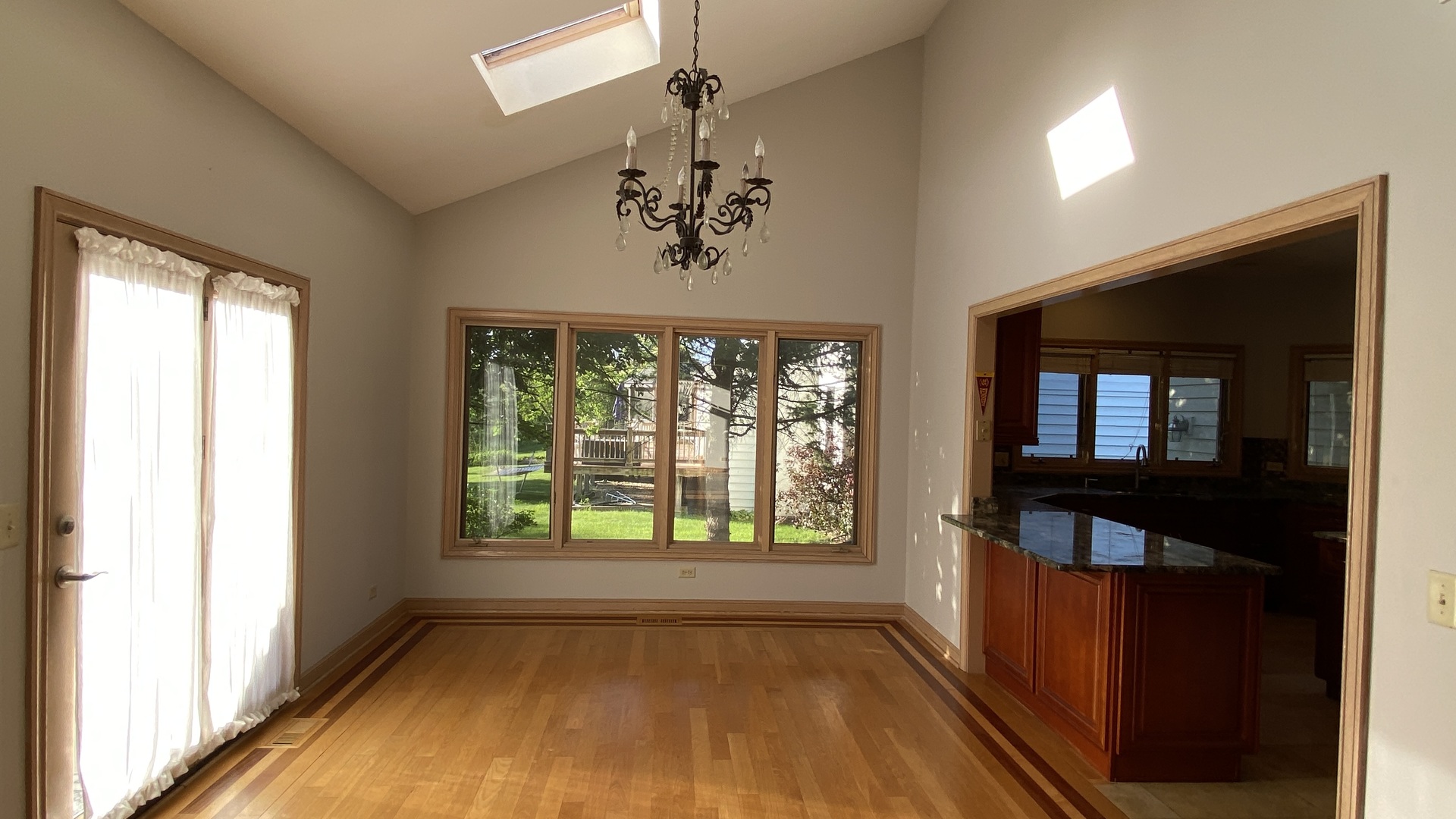 817 Turnbridge Circle Naperville, IL 60540 - Photo 16 of 42 wooden floor in an empty room with a window