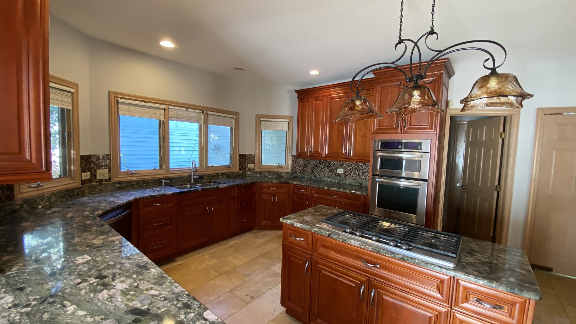 817 Turnbridge Circle Naperville, IL 60540 - Photo 17 of 42 a kitchen with stainless steel appliances granite countertop a sink a stove and a refrigerator