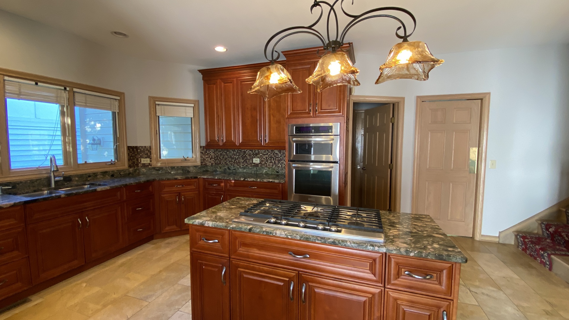 817 Turnbridge Circle Naperville, IL 60540 - Photo 21 of 42 a kitchen with stainless steel appliances granite countertop a stove and a sink