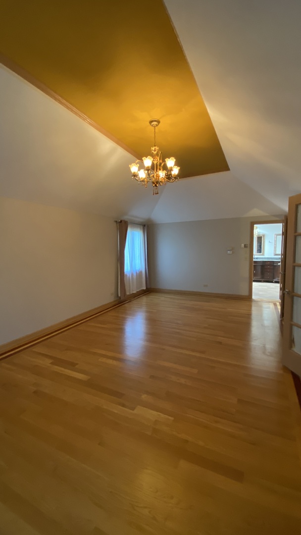 817 Turnbridge Circle Naperville, IL 60540 - Photo 28 of 42 a view of an empty room with window and wooden floor