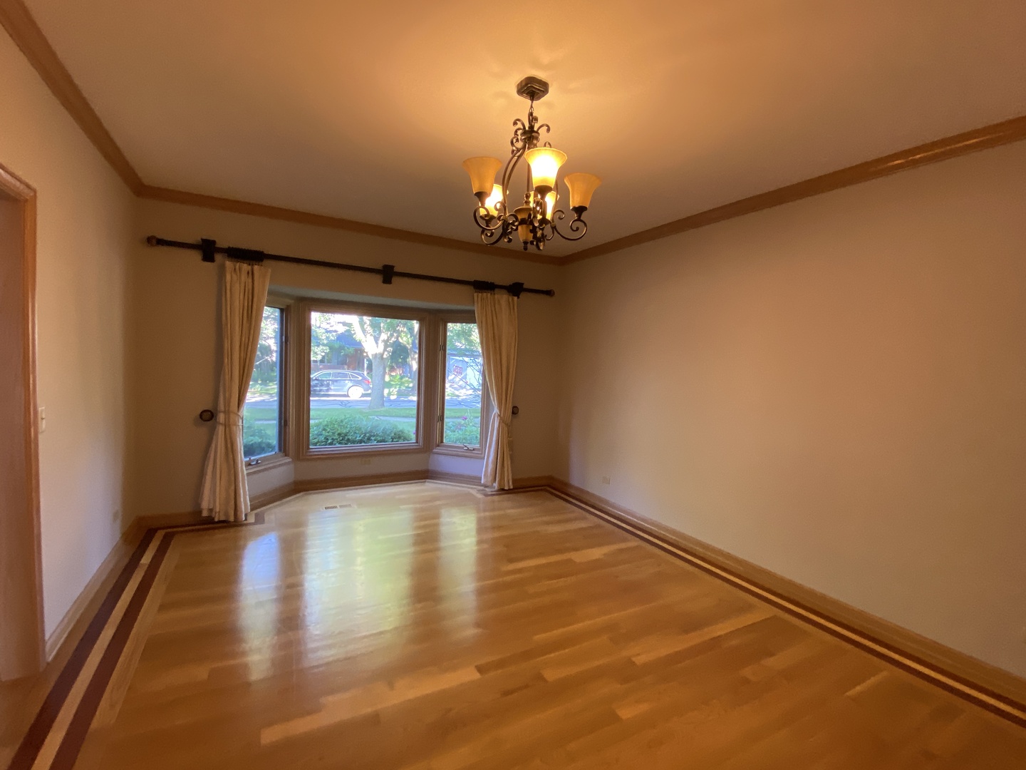 817 Turnbridge Circle Naperville, IL 60540 - Photo 4 of 42 a view of an empty room with wooden floor and a window