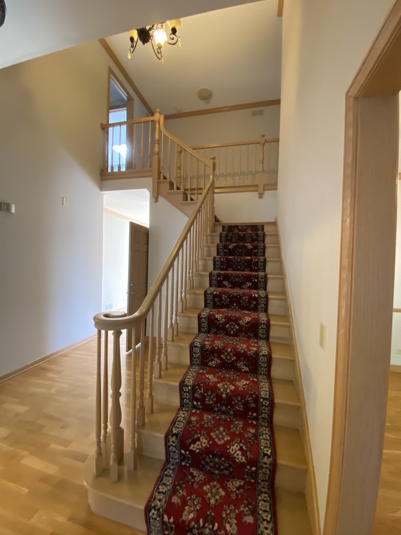 817 Turnbridge Circle Naperville, IL 60540 - Photo 6 of 42 a view of entryway and hall with wooden floor