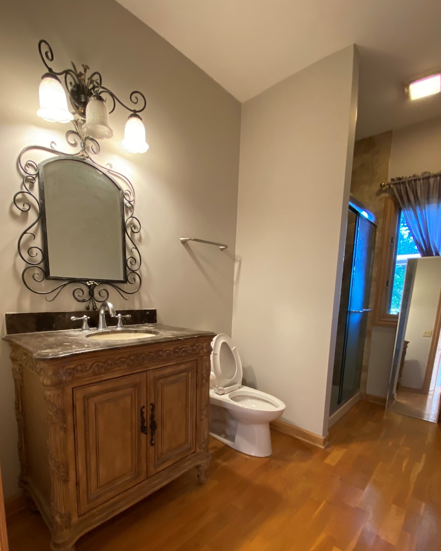 817 Turnbridge Circle Naperville, IL 60540 - Photo 8 of 42 a bathroom with a toilet sink and mirror