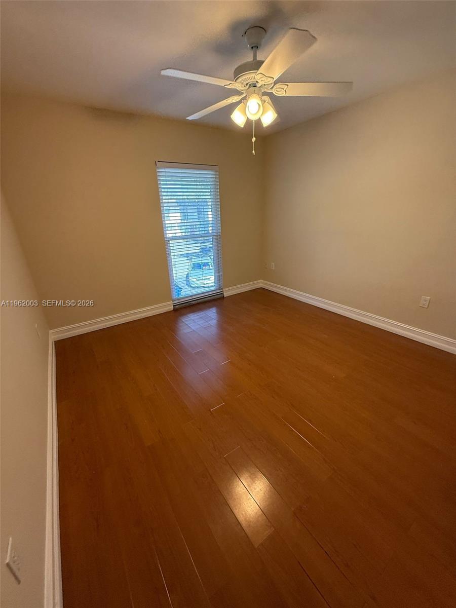 3326 Farragut Street, Unit 6D Hollywood, FL 33021 - Photo 12 of 25 an empty room with a chandelier fan and windows