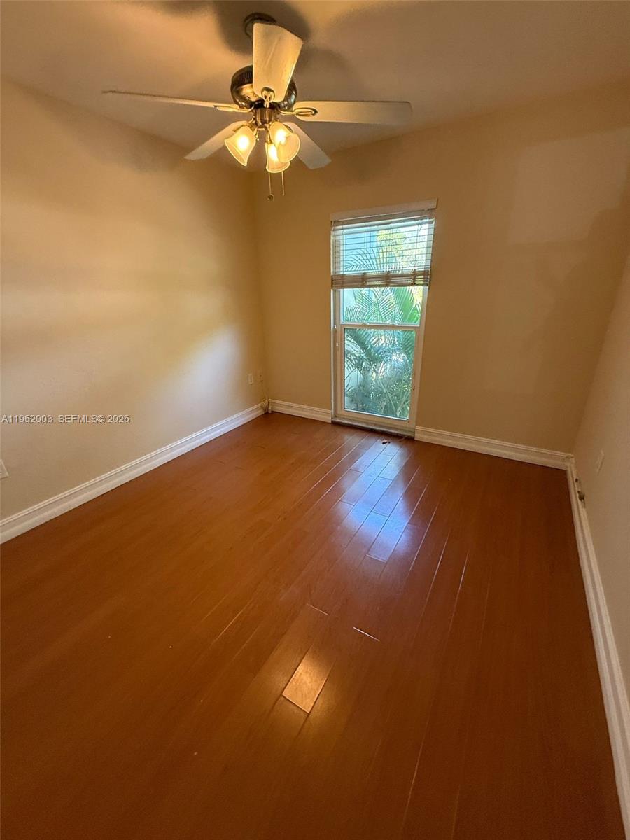 3326 Farragut Street, Unit 6D Hollywood, FL 33021 - Photo 13 of 25 an empty room with a window and wooden floor