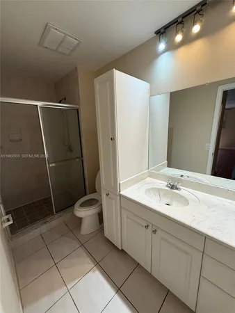 a bathroom with a toilet sink and shower