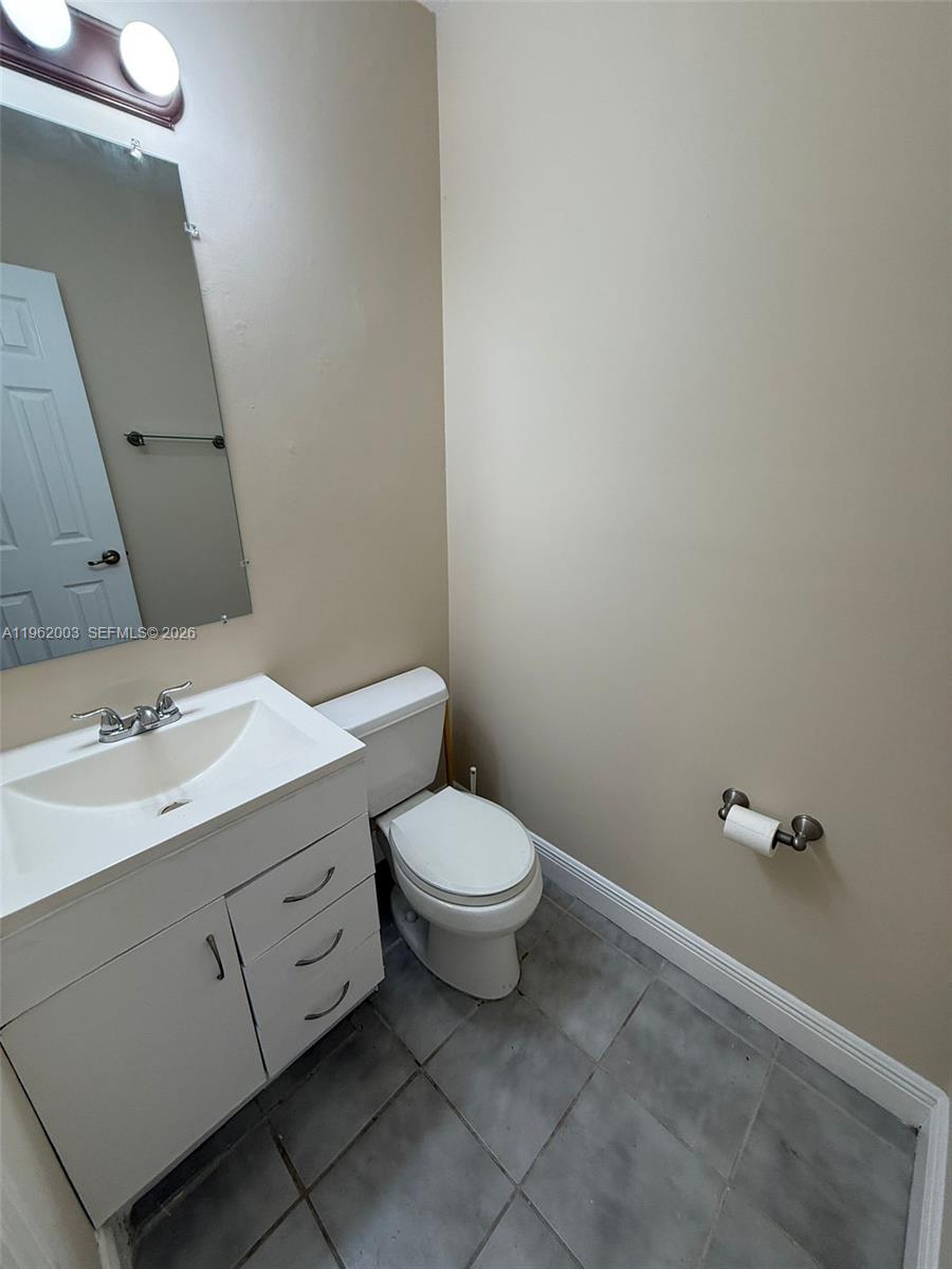 3326 Farragut Street, Unit 6D Hollywood, FL 33021 - Photo 6 of 25 a bathroom with a toilet sink and mirror