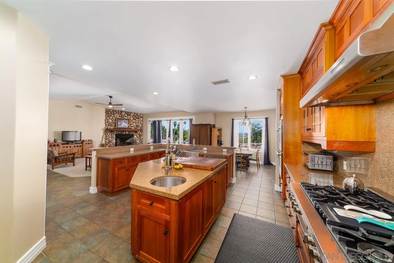 32070 Vía Vera Bonsall, CA 92003 - Photo 11 of 51 a kitchen with sink stove and refrigerator