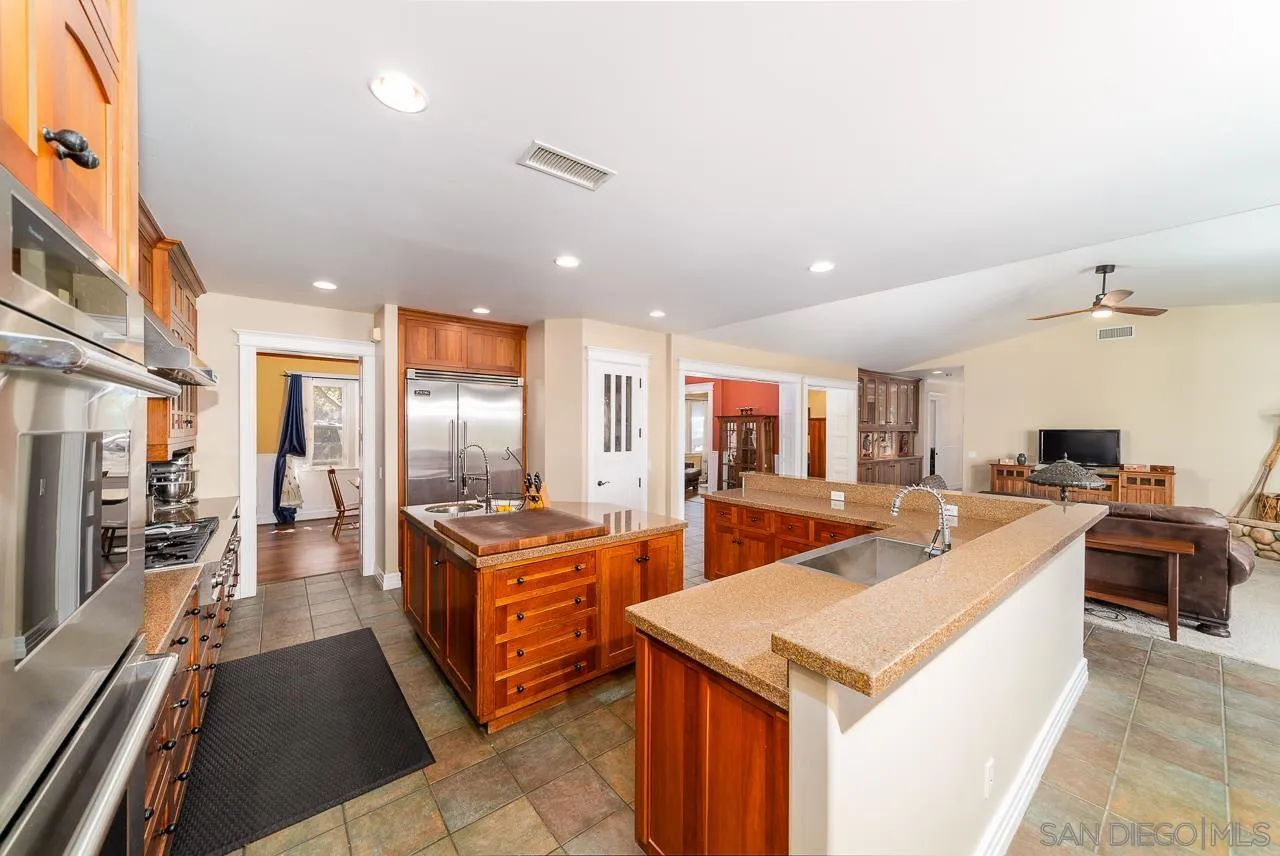 32070 Vía Vera Bonsall, CA 92003 - Photo 12 of 51 a large kitchen with stainless steel appliances