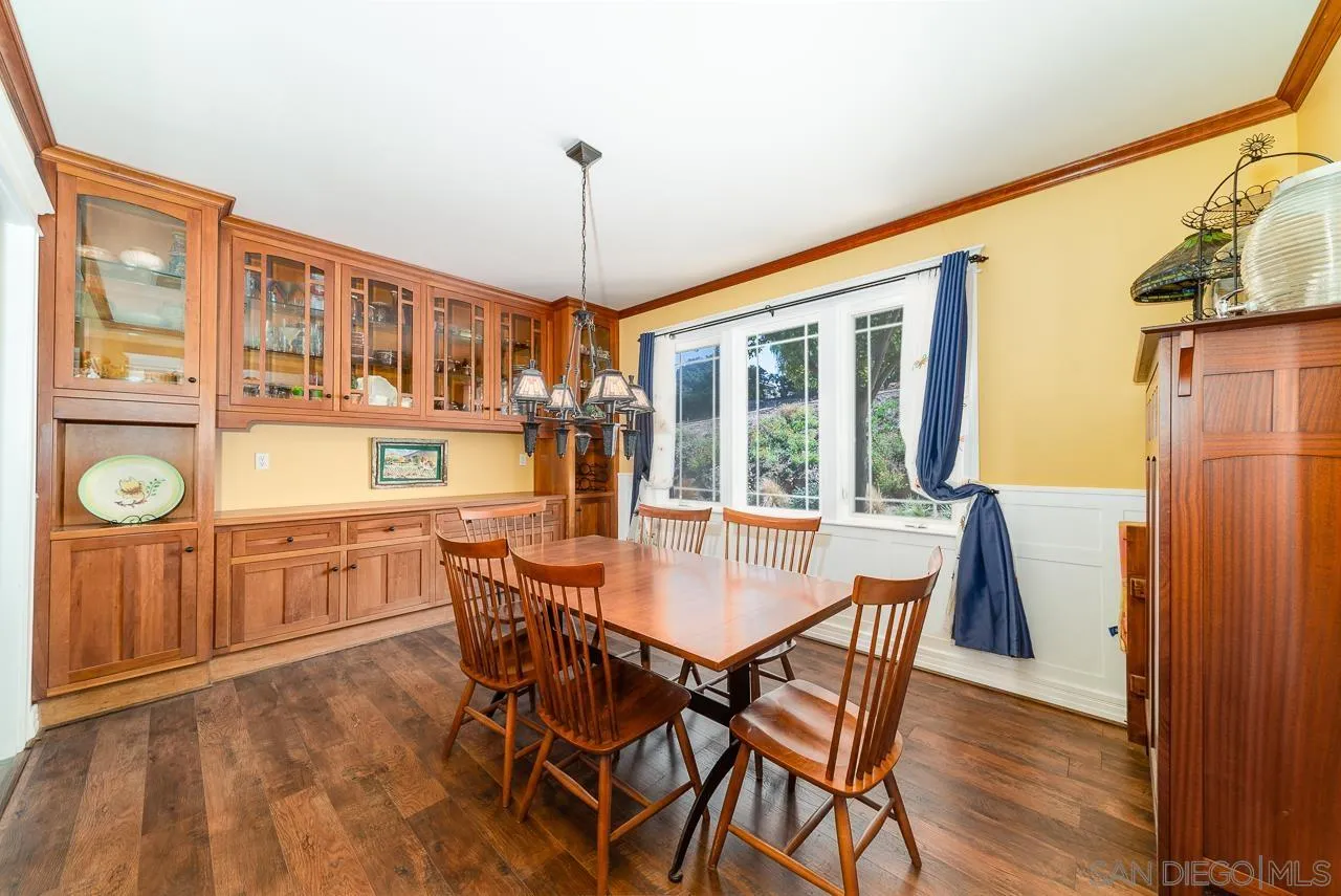 32070 Vía Vera Bonsall, CA 92003 - Photo 18 of 51 a dining room with furniture a chandelier and wooden floor
