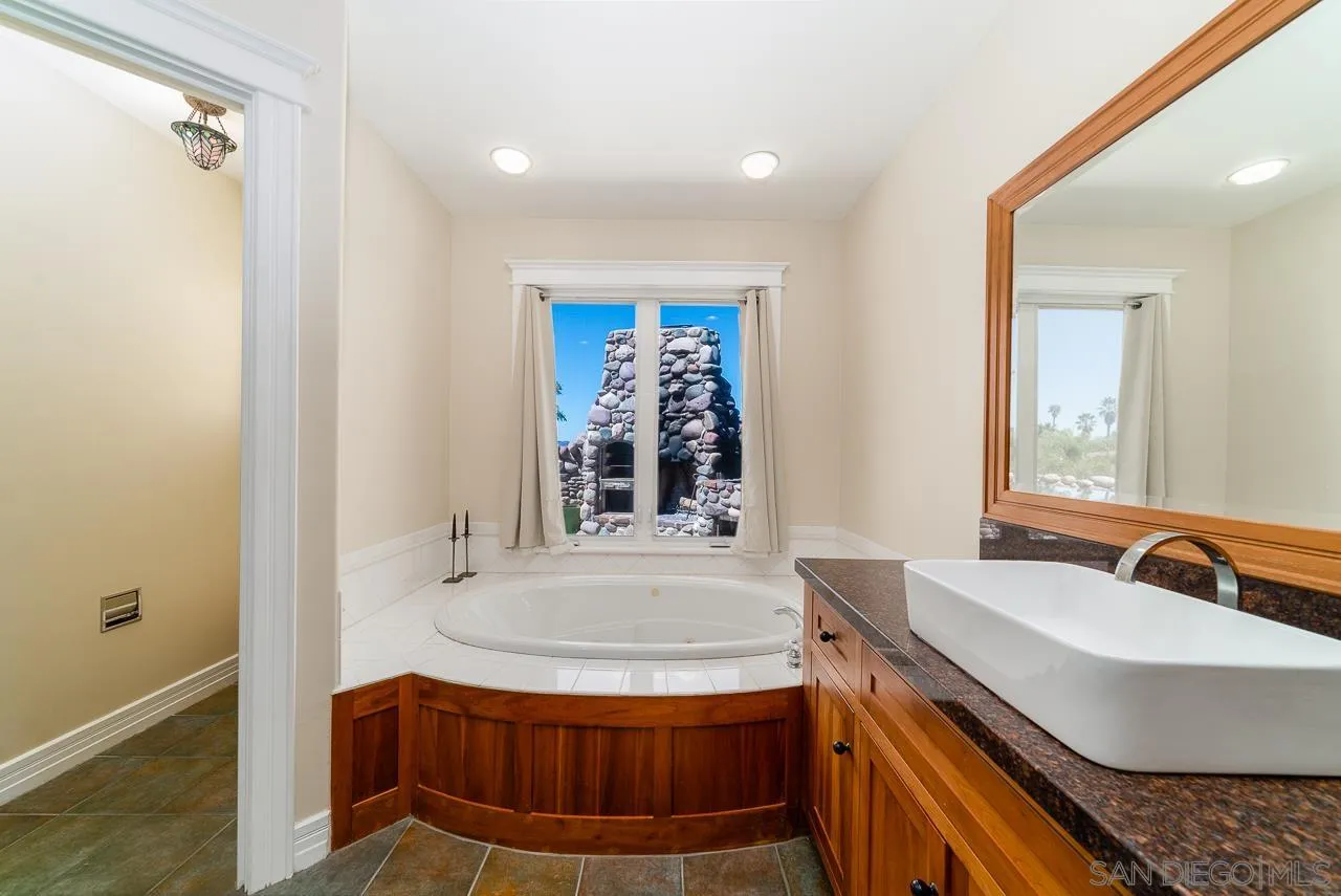 32070 Vía Vera Bonsall, CA 92003 - Photo 23 of 51 a bathroom with a sink and a mirror