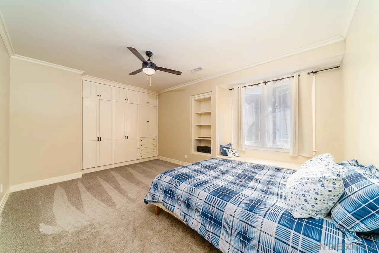 32070 Vía Vera Bonsall, CA 92003 - Photo 26 of 51 a bedroom with a bed chandelier and a window