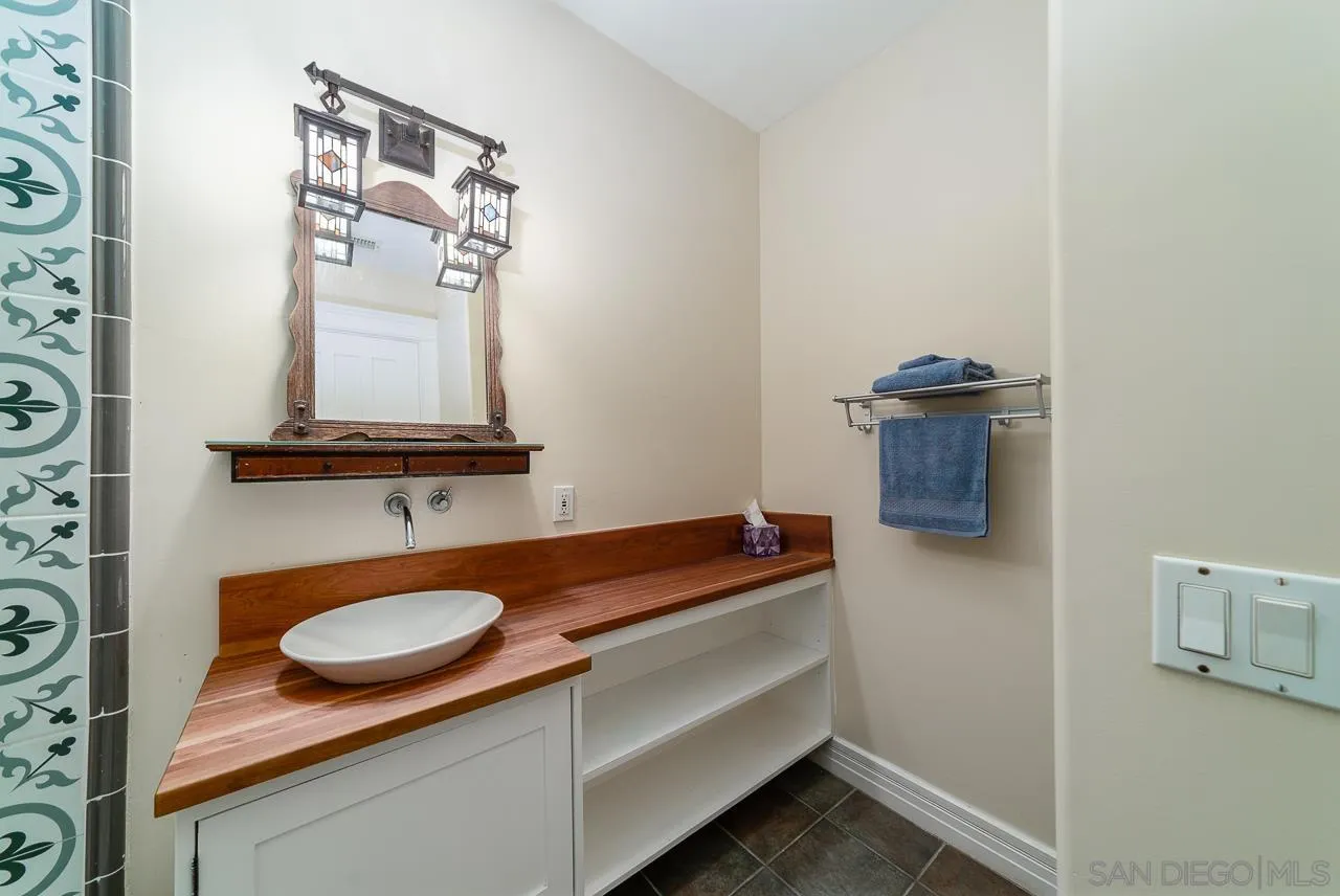 32070 Vía Vera Bonsall, CA 92003 - Photo 33 of 51 a bathroom with a sink and a mirror