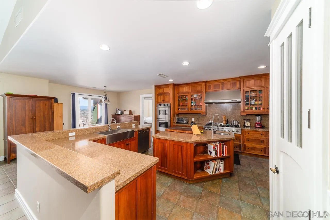 32070 Vía Vera Bonsall, CA 92003 - Photo 9 of 51 a kitchen with stainless steel appliances a sink a stove and a refrigerator
