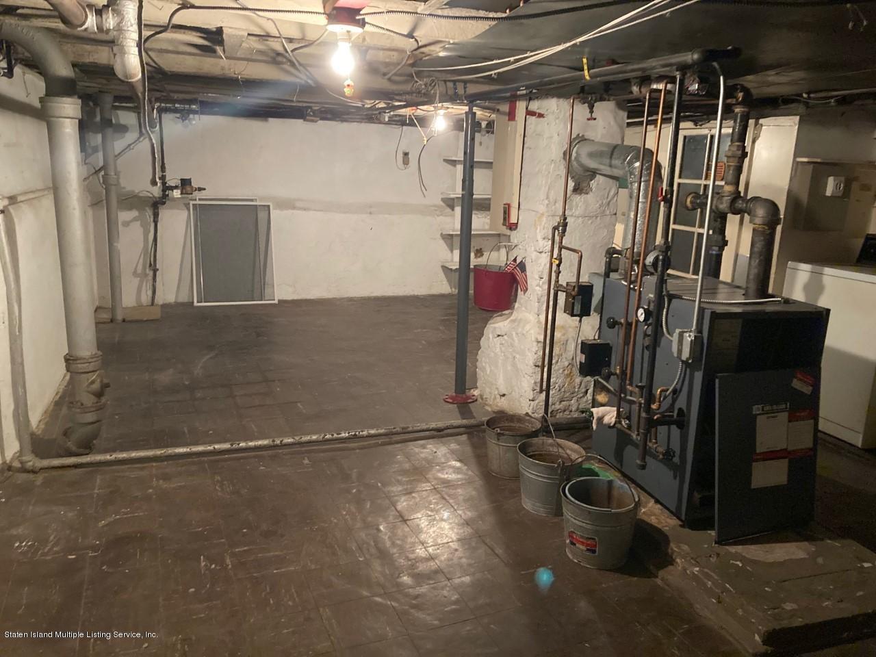449 Lake Street Brooklyn, NY 11223 - Photo 13 of 14 a view of a room with water heater and a cabinet
