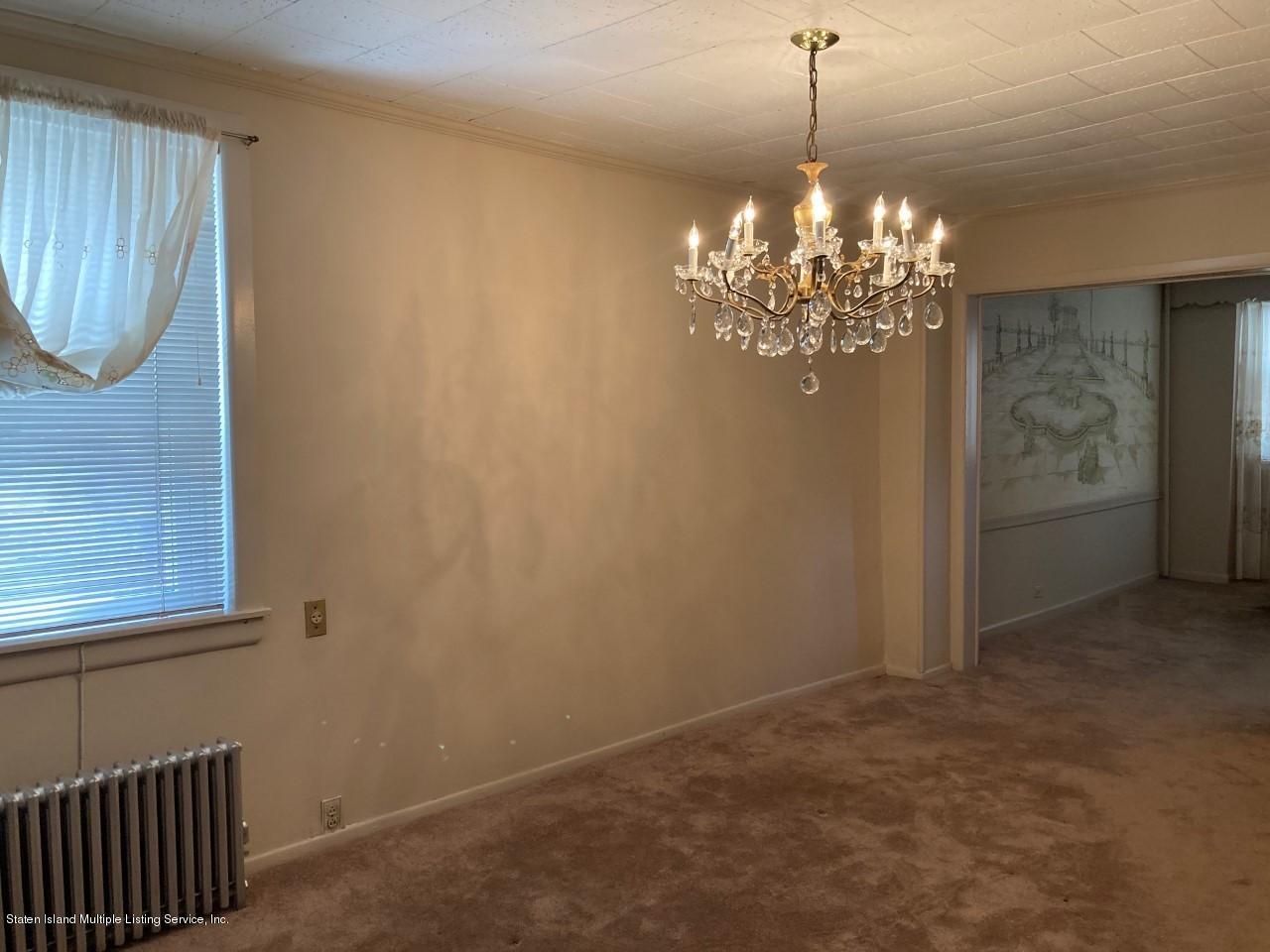 449 Lake Street Brooklyn, NY 11223 - Photo 5 of 14 a view of a chandelier in big room with wooden floor