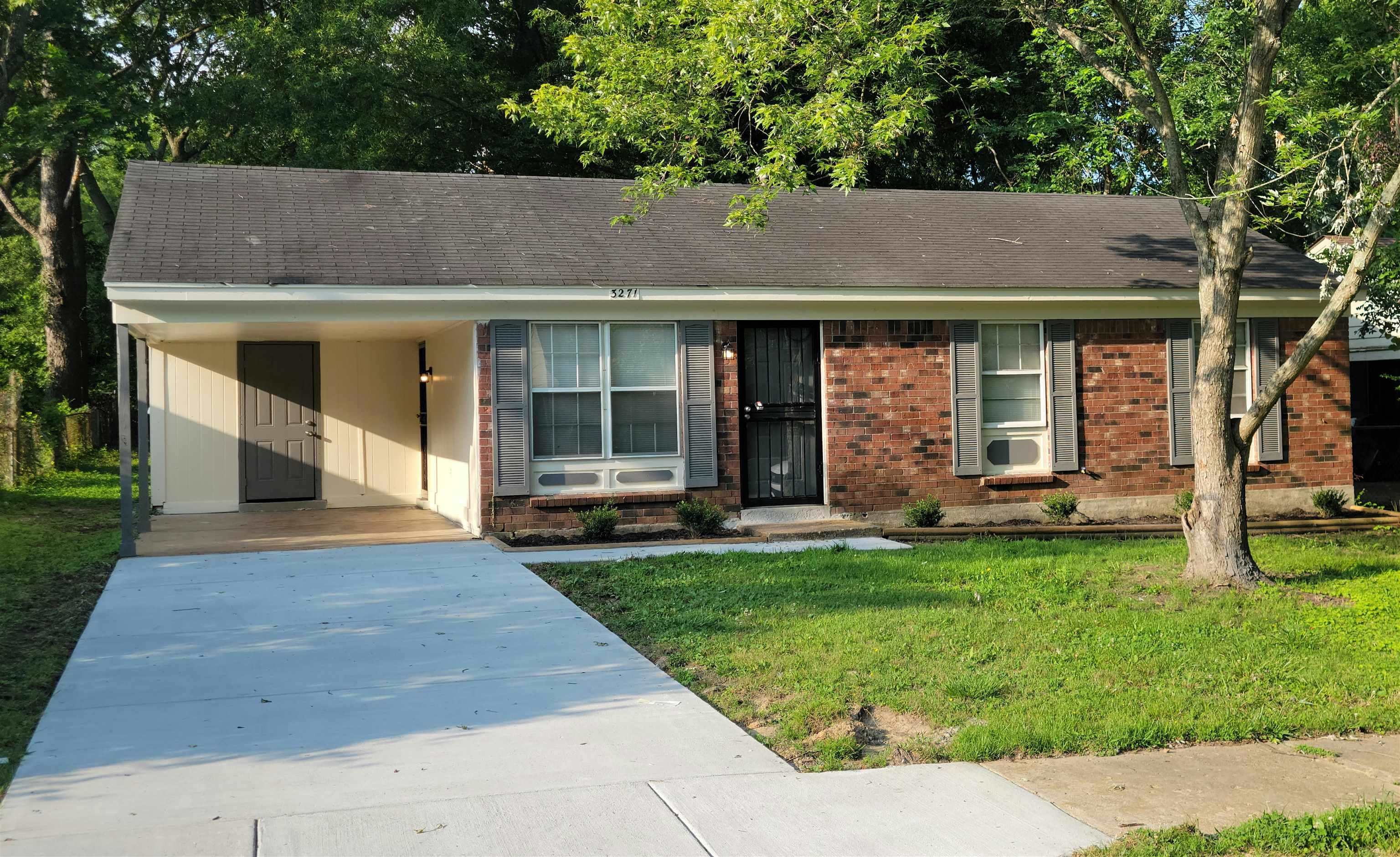 3271 Flower Valley Avenue Memphis, TN 38128 - Photo 1 of 5 View of front of property with driveway, a carport, a front lawn, and brick siding