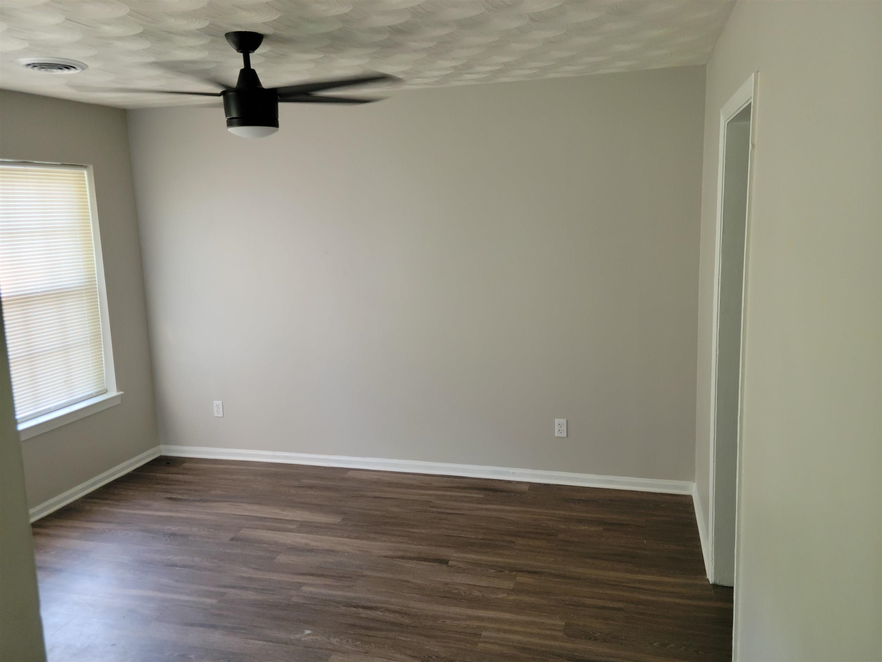 3271 Flower Valley Avenue Memphis, TN 38128 - Photo 3 of 5 Spare room featuring ceiling fan, dark wood-type flooring, and a textured ceiling