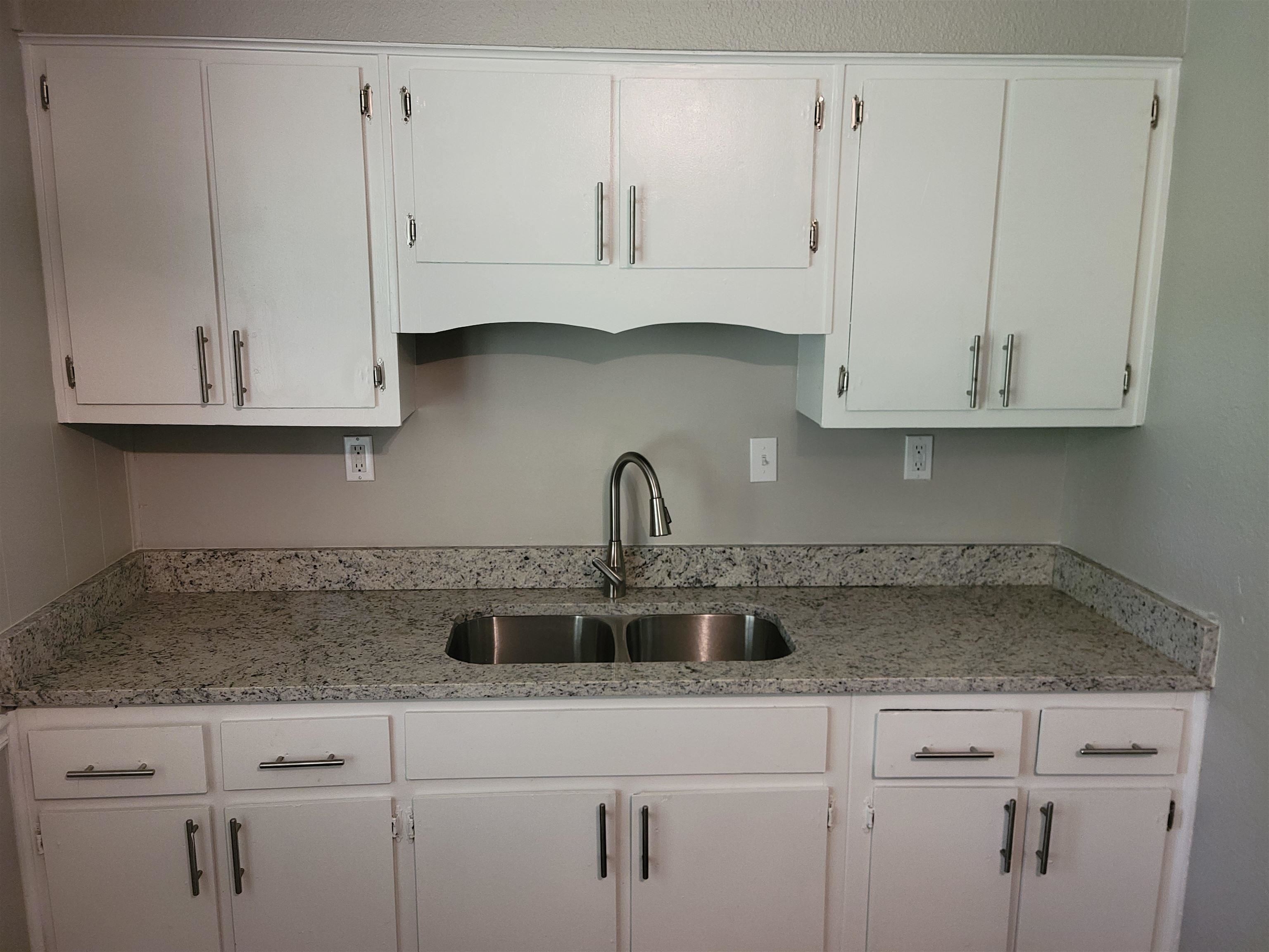 3271 Flower Valley Avenue Memphis, TN 38128 - Photo 5 of 5 Kitchen featuring white cabinetry and light stone countertops