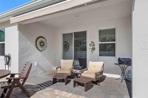 a view of a house with backyard sitting area and garden