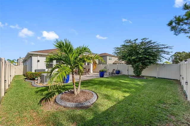an aerial view of house with yard swimming pool and ocean view