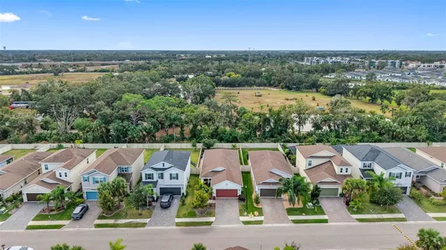 an aerial view of residential houses with outdoor space