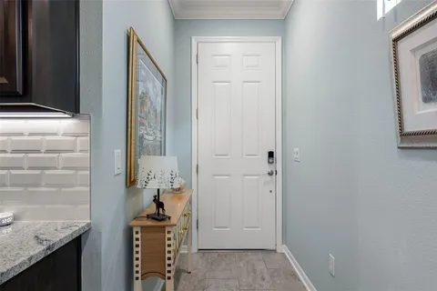 a kitchen with granite countertop stainless steel appliances a sink cabinets a refrigerator and a stove top oven