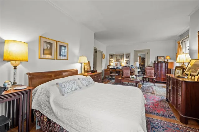 a living room with furniture a rug and a window