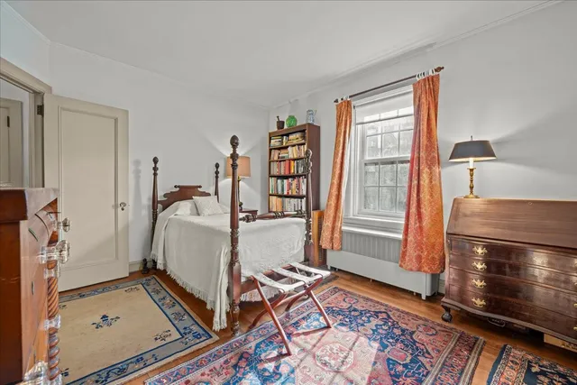 a bed sitting in a bedroom next to a window