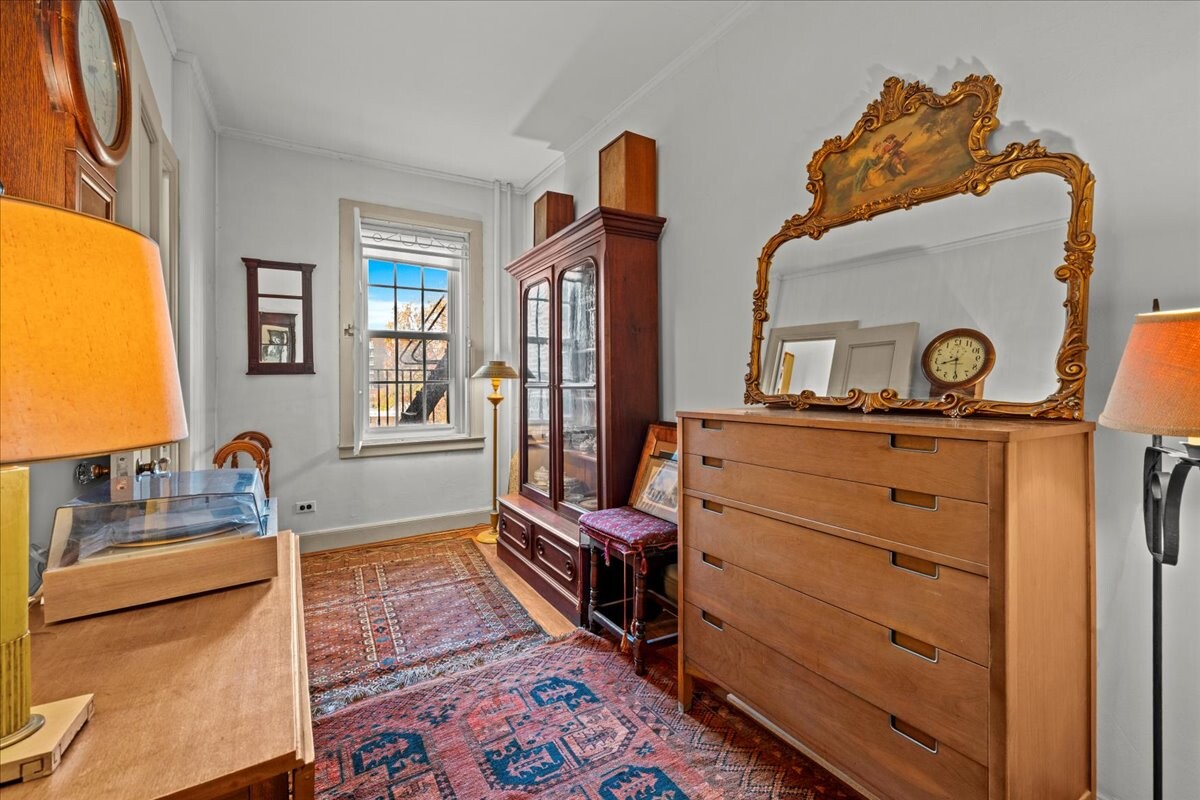 525 West 238th Street, Unit 2B Bronx, NY 10463 - Photo 18 of 31 a bedroom with a bed and wooden floor