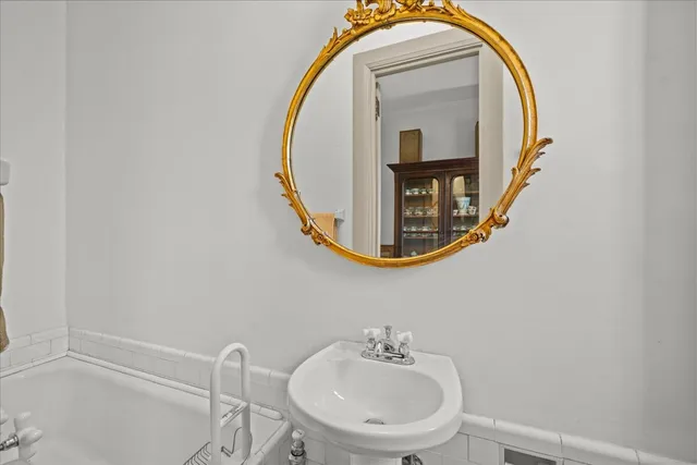 a bathroom with a sink a mirror and a toilet