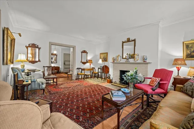 a living room with furniture a rug and a flat screen tv