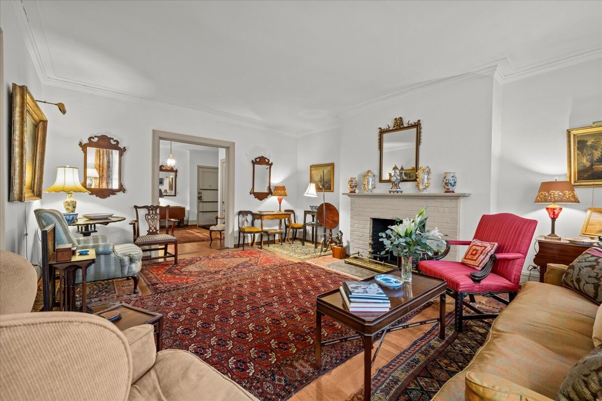 525 West 238th Street, Unit 2B Bronx, NY 10463 - Photo 3 of 31 a living room with furniture a rug and a fireplace