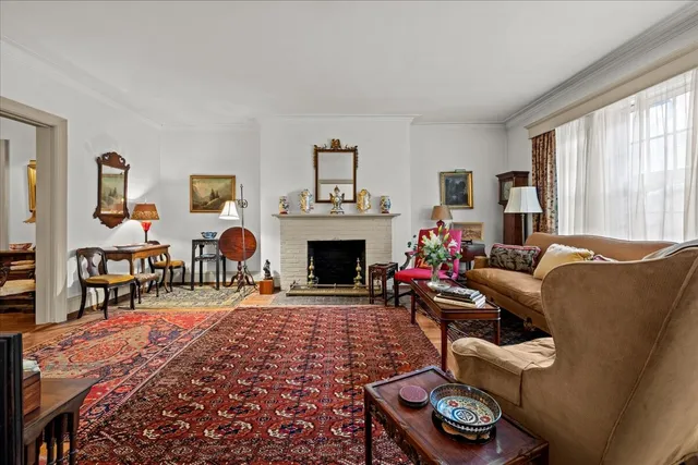 a living room with furniture a rug and a fireplace