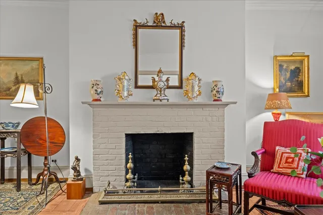 a living room with furniture a window and a fireplace
