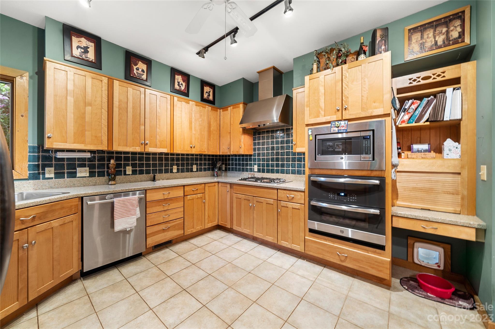 193 Eagle Ridge Clyde, NC 28721 - Photo 11 of 48 a kitchen with stainless steel appliances a stove sink and cabinets