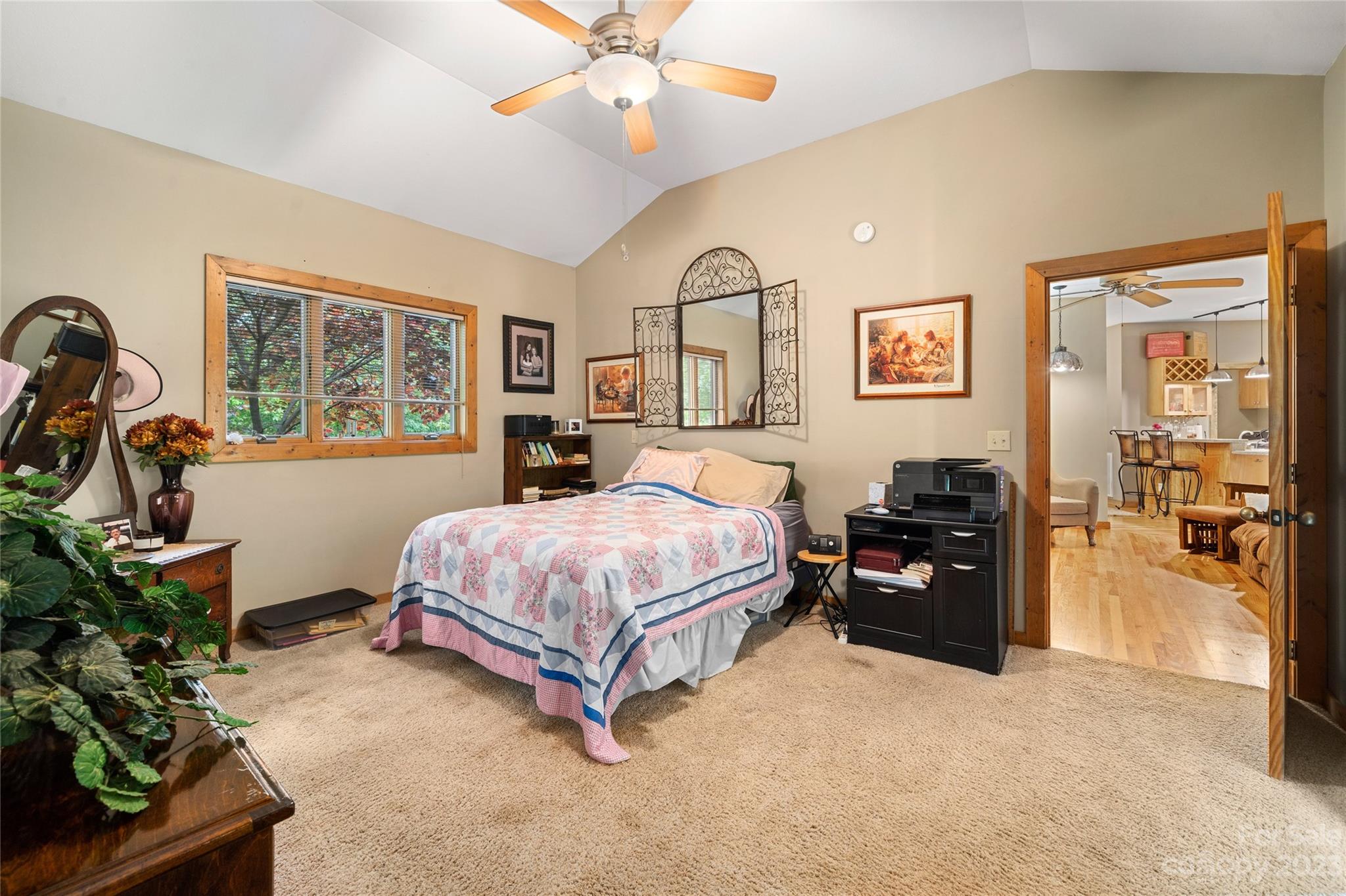 193 Eagle Ridge Clyde, NC 28721 - Photo 17 of 48 a spacious bedroom with a bed and a chandelier