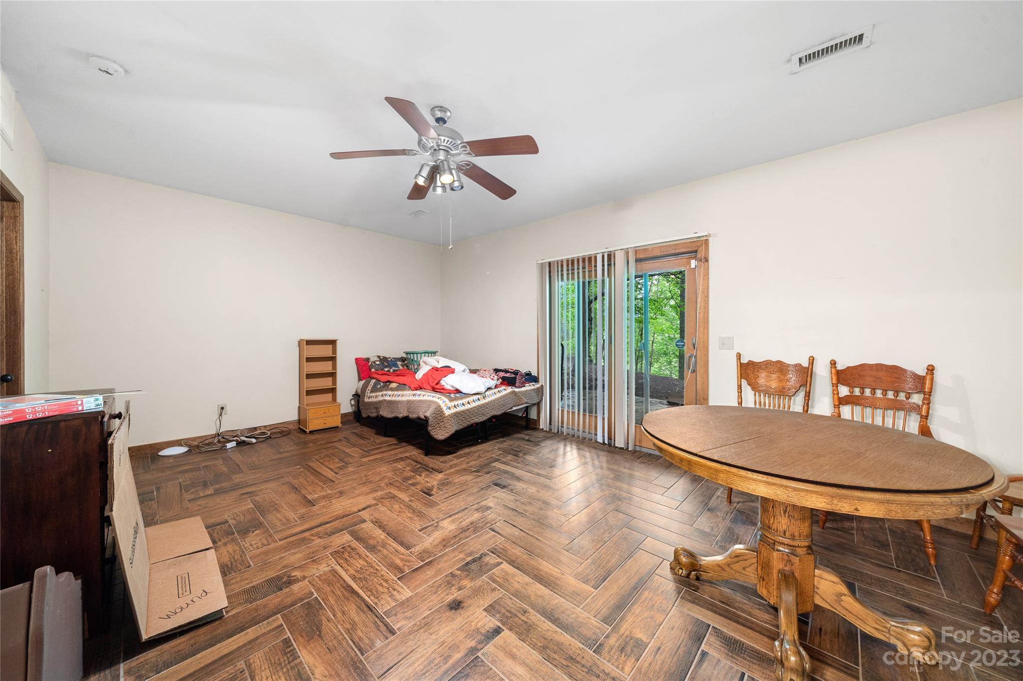 193 Eagle Ridge Clyde, NC 28721 - Photo 26 of 48 a bedroom with a bed and a chandelier