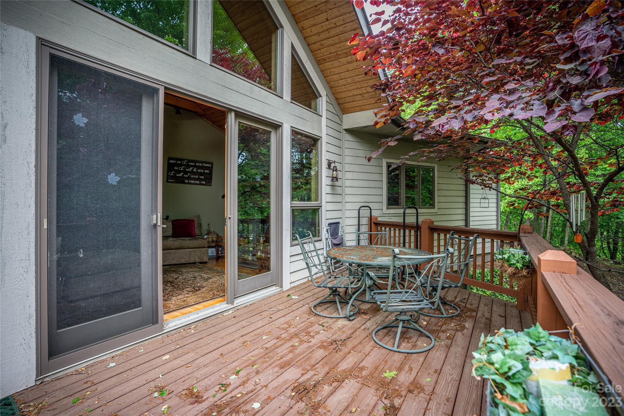 193 Eagle Ridge Clyde, NC 28721 - Photo 33 of 48 a view of a patio with table and chairs and wooden floor