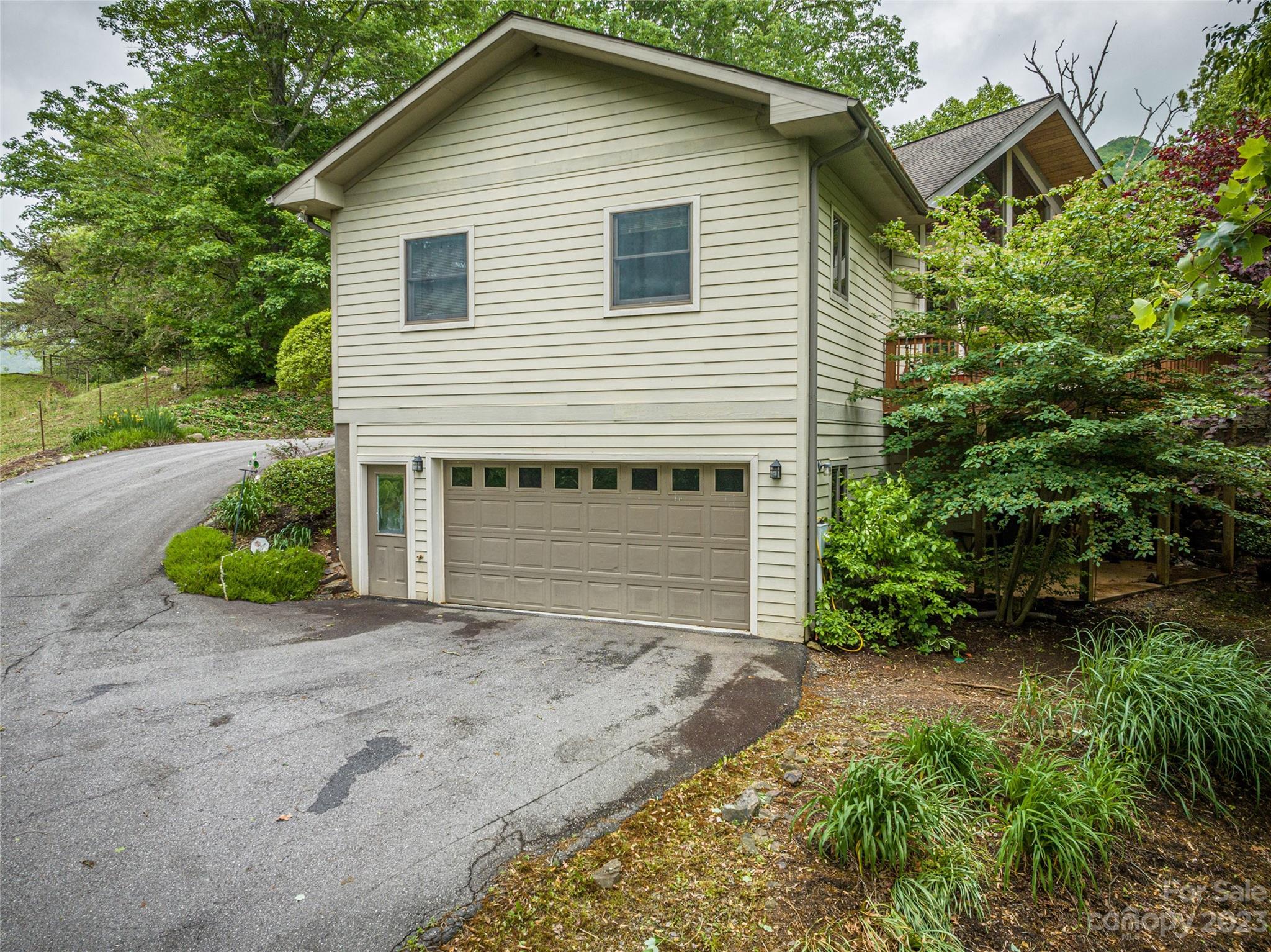 193 Eagle Ridge Clyde, NC 28721 - Photo 42 of 48 a front view of a house with a yard and garage