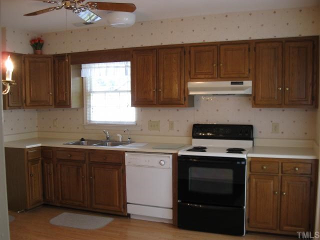 2701 Cottage Circle Raleigh, NC 27613 - Photo 6 of 10 a kitchen with a stove sink and cabinets