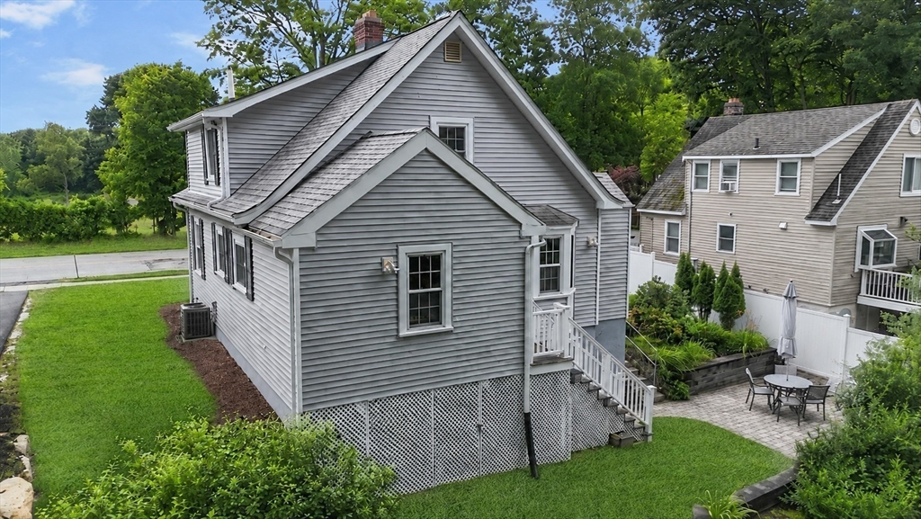 46 MacArthur Road Stoneham, MA 02180 - Photo 26 of 41 a view of a house with a yard plants and a large tree