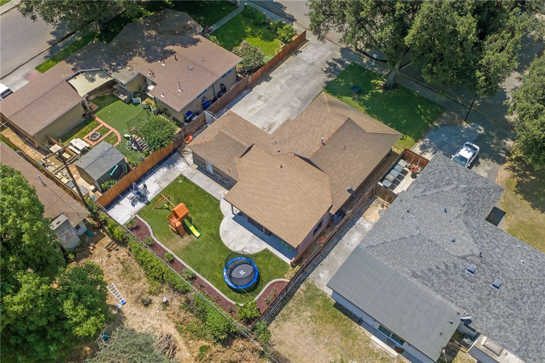 4869 Serrano Place Riverside, CA 92504 - Photo 8 of 40 Great backyard layout with lawn, patio space, play area, and perimeter fencing for added privacy.