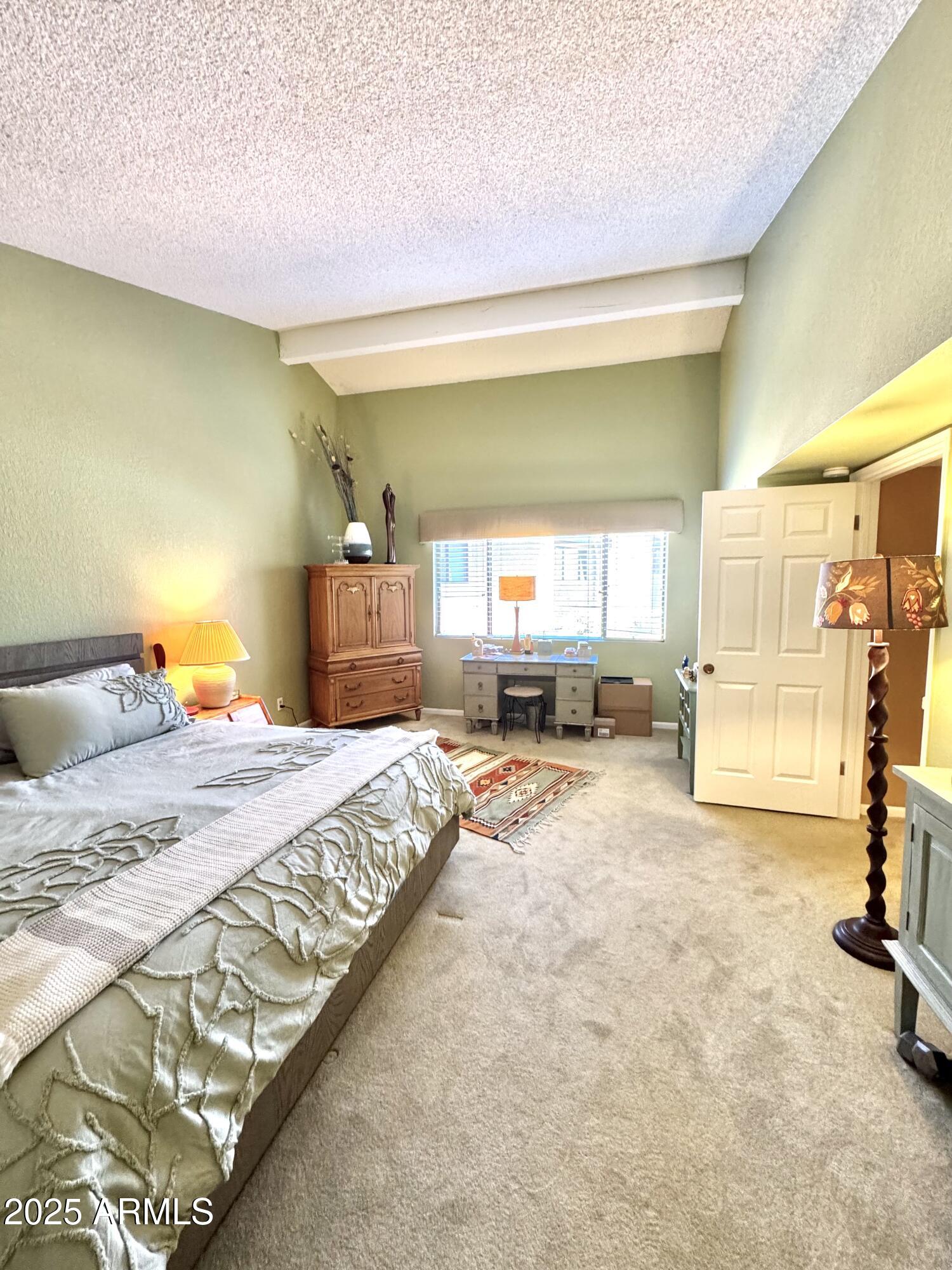 7432 Hum Road, Unit 203 Carefree, AZ 85377 - Photo 12 of 21 a bed room with a bed and a view of kitchen