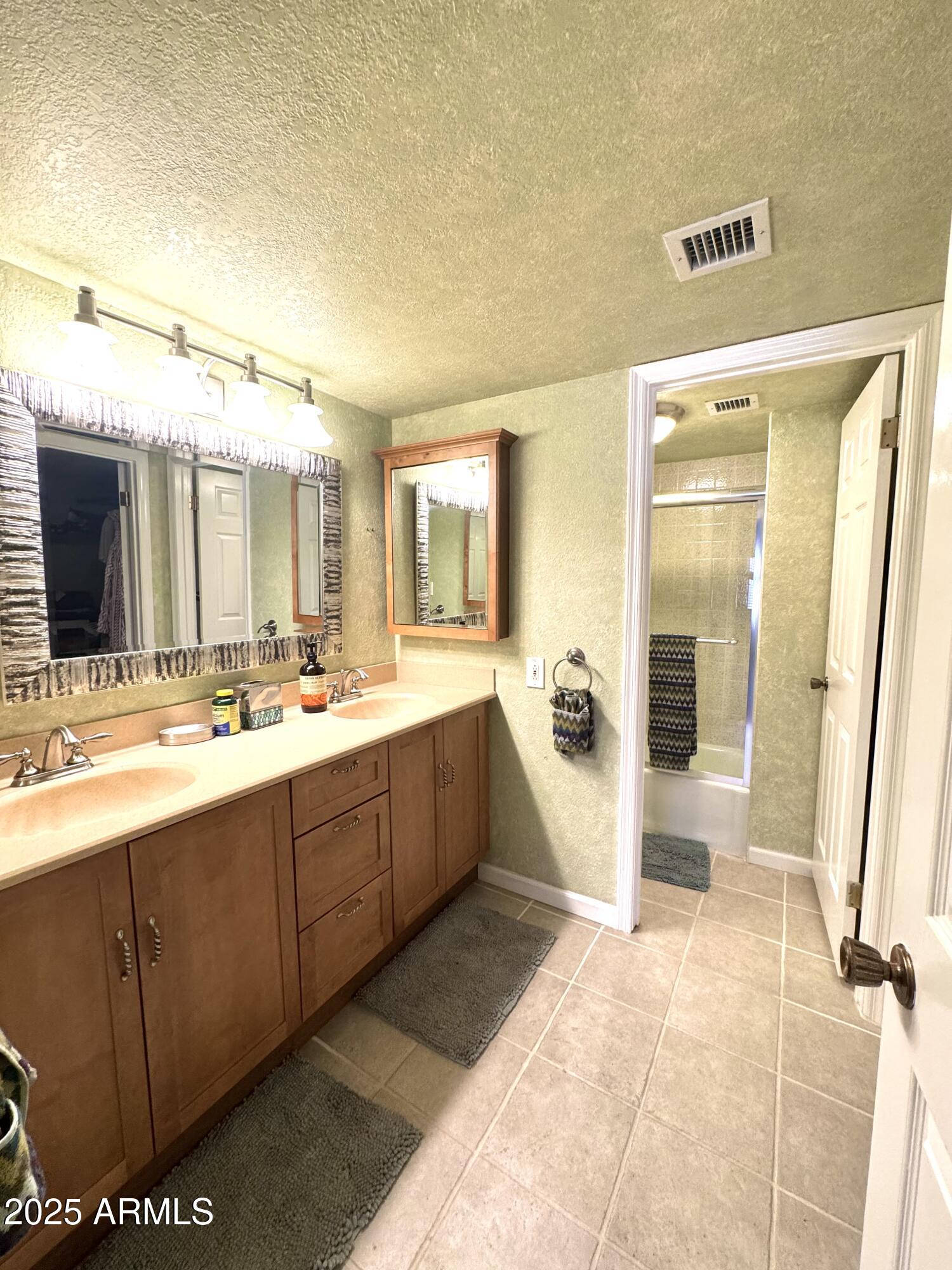 7432 Hum Road, Unit 203 Carefree, AZ 85377 - Photo 14 of 21 a spacious bathroom with a tub sink mirror and a shower
