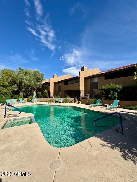 7432 Hum Road, Unit 203 Carefree, AZ 85377 - Photo 17 of 21 a view of a patio with table and chairs potted plants with wooden fence