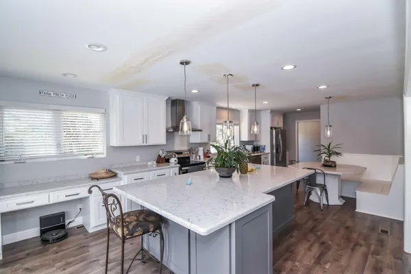 a kitchen with a table chairs sink and cabinets