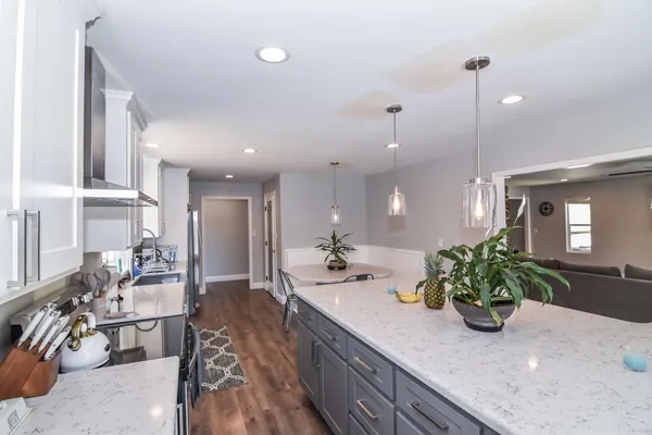a kitchen with counter top space and living room
