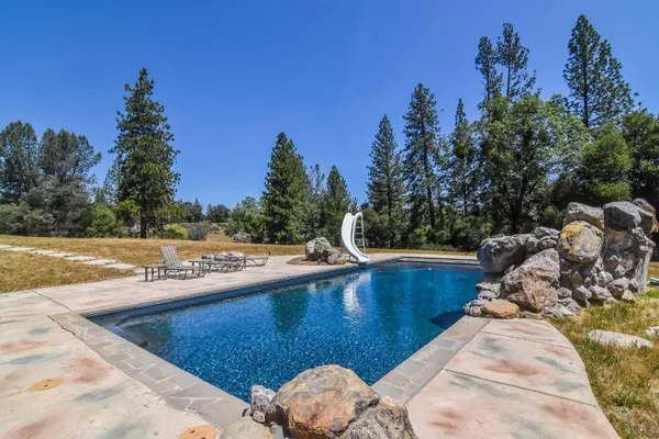 a view of a swimming pool with a yard